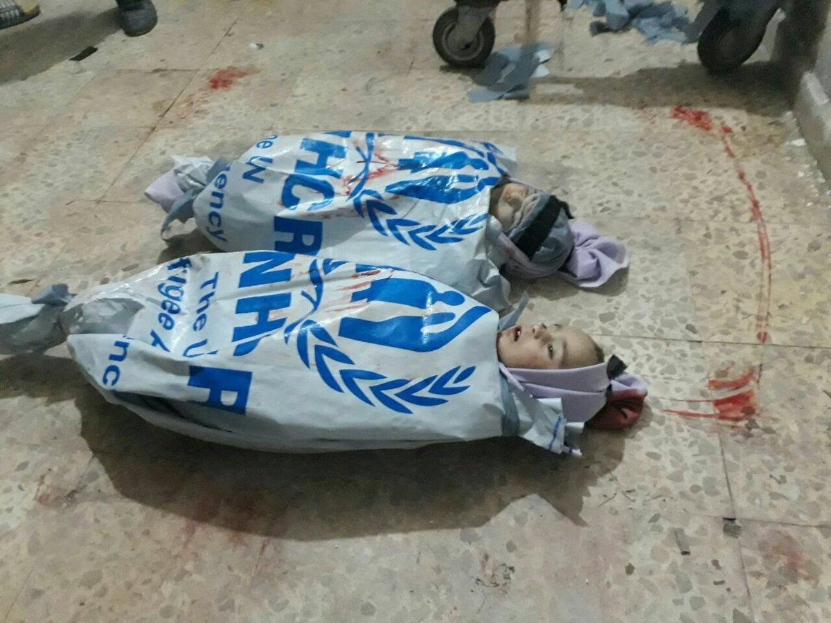 GRAPHIC IMAGE  The bodies of two children wrapped in U.N. aid bags in eastern Ghouta. 