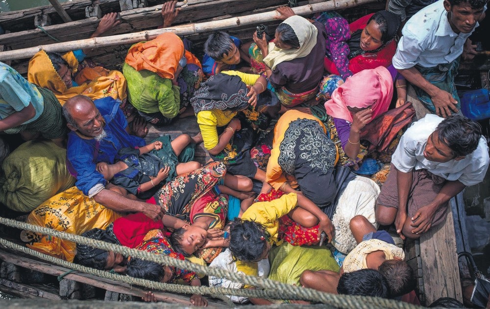 Rohingya refugees arriving by boat at Shah Parir Dwip on the Bangladesh side of the Naf River on Sept. 12.