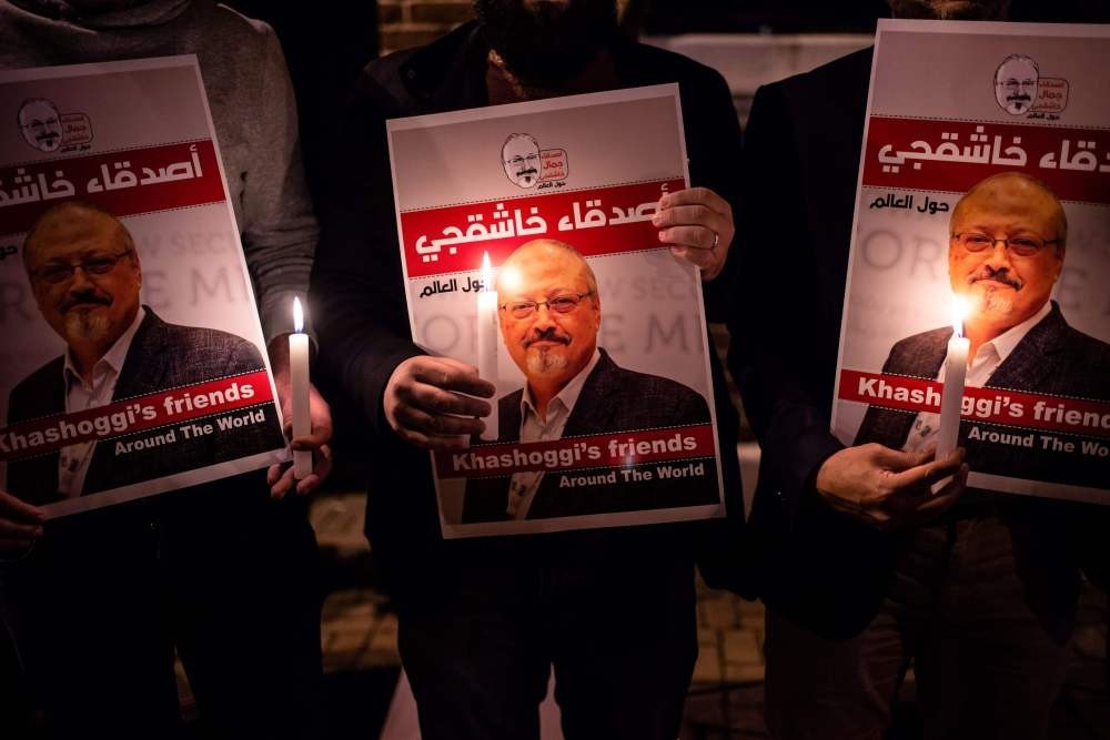 People lit candles and held posters picturing murdered Saudi journalist Jamal Khashoggi during a gathering outside the Saudi Consulate in Istanbul, Oct. 25.