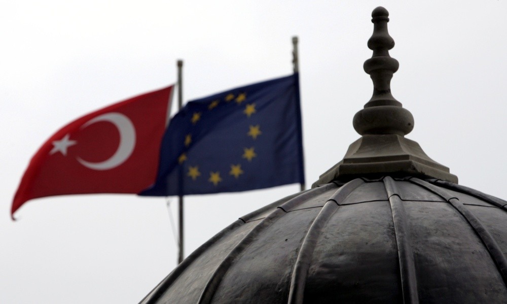 The Turkish and European Union flags waving side by side in Istanbul, where the minarets and domes of mosques and churches dominate the cityu2019s silhouette.