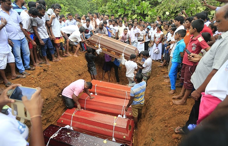 In this Saturday, May 27, 2017, file photo, Sri Lankan villagers prepare to bury victims of a landslide at a cemetery in Bellana village, in Kalutara district in, Sri Lanka. Sri Lanka has appealed for outside help as dozens were killed in floods and 