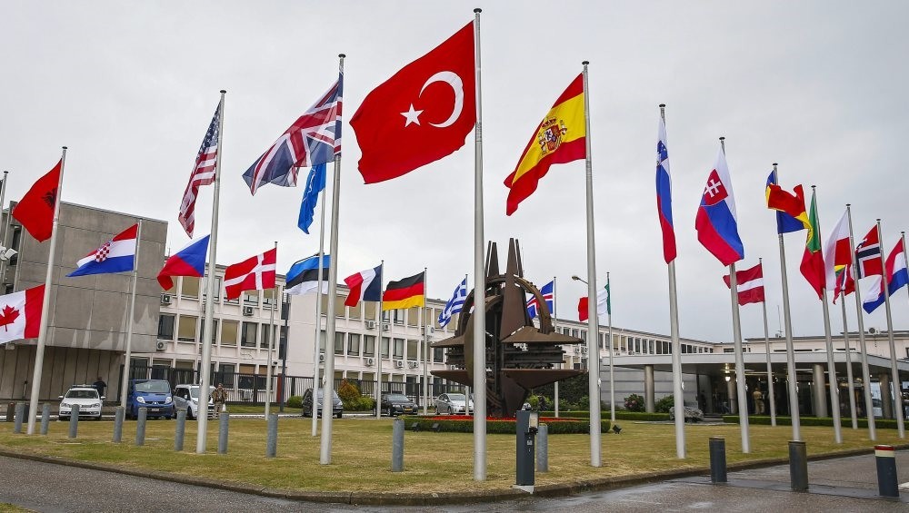 Flags of NATO member countries fly in front of the NATO headquarters in Brussels, Belgium, July 28, 2015. 