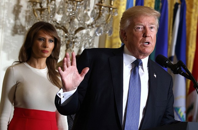 President Donald Trump speaks during an event at the White House in Washington, as first lady Melania Trump listens. (AP Photo)