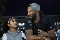 Bryant and his daughter Gianna watch the U.S. national championships swimming meet in Irvine, July 26, 2018. (AP Photo)