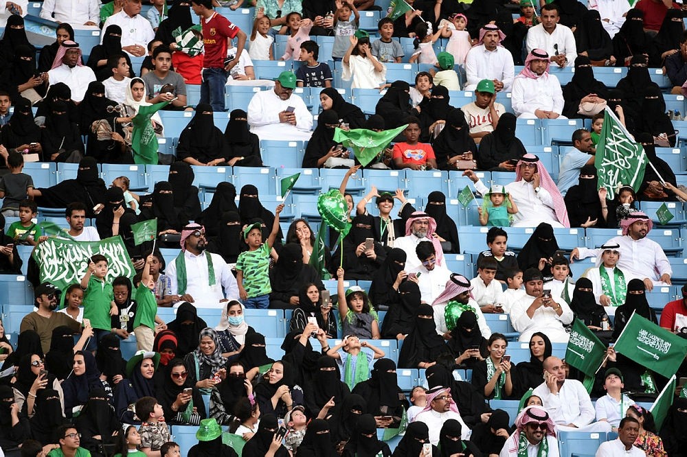 Saudi families sit in a stadium waving national flags, to attend an event in the capital Riyadh on September 23, 2017 commemorating the anniversary of the founding of the kingdom. (AFP Photo)
