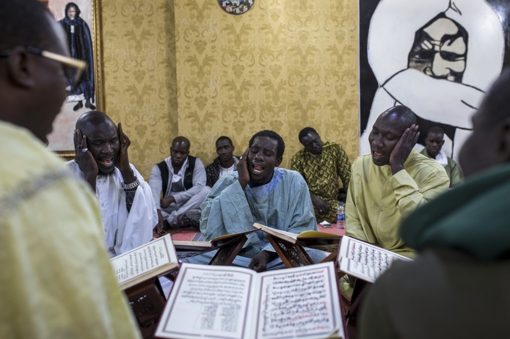 Senegalese migrants recite hymns in a religious ritual in Istanbul. The city is home to a large expat population from African countries.