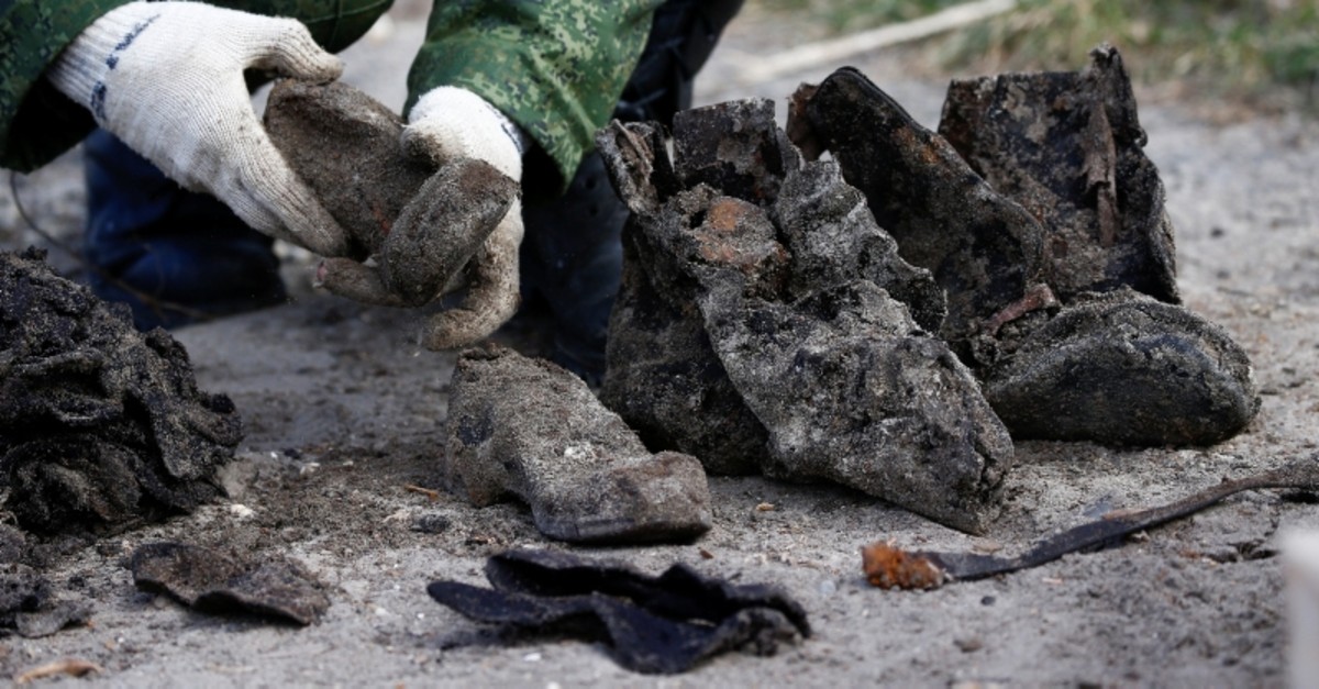 A soldier takes part in the exhumation of a mass grave containing the remains of about 730 prisoners of a former Jewish ghetto, discovered at a construction site in the center of Brest, Belarus February 26, 2019. (Reuters Photo)