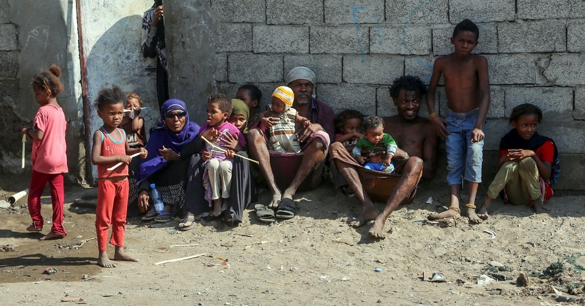 Members of a poor Yemeni family sit together next to a wall, Hodeidah, Jan. 11, 2019.