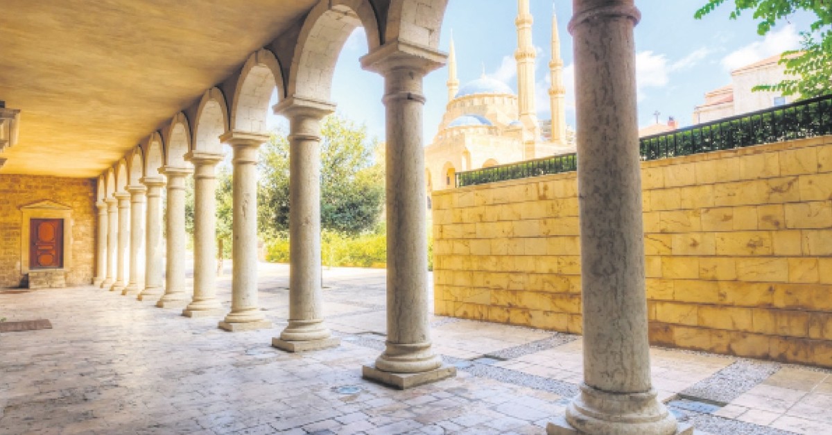 The Mohammad Al-Amin Mosque situated in downtown Beirut, Lebanon as viewed through the pillars of the Greek Orthodox church of St George.