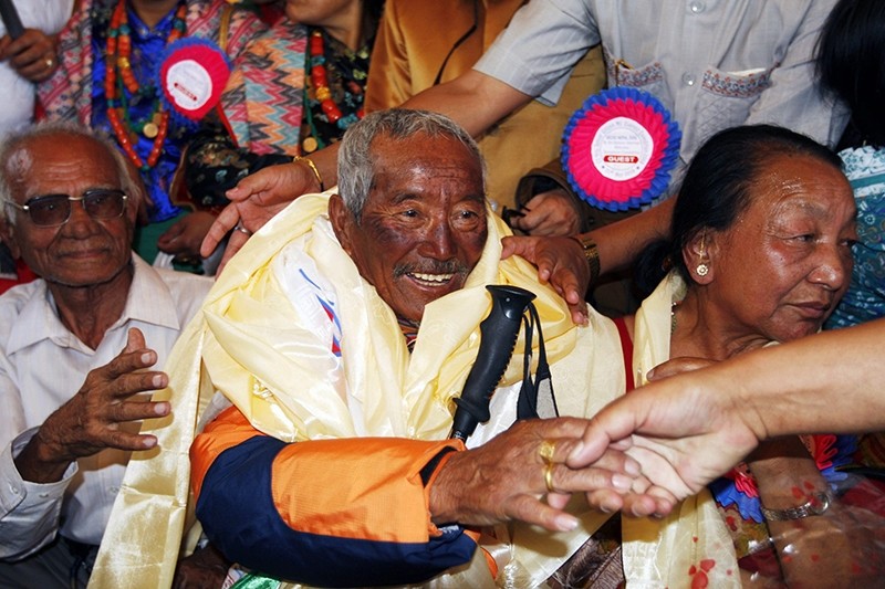 In this May 31, 2008 file photo, Min Bahadur Sherchan, center, who became the oldest person to climb Mount Everest on May 25, 2008, shakes hands on his arrival in Katmandu. (AP Photo)