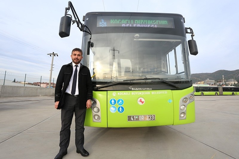 Bus driver Hayrettin u015eahin stands in front of his bus in Turkey's Kocaeli province (AA Photo)