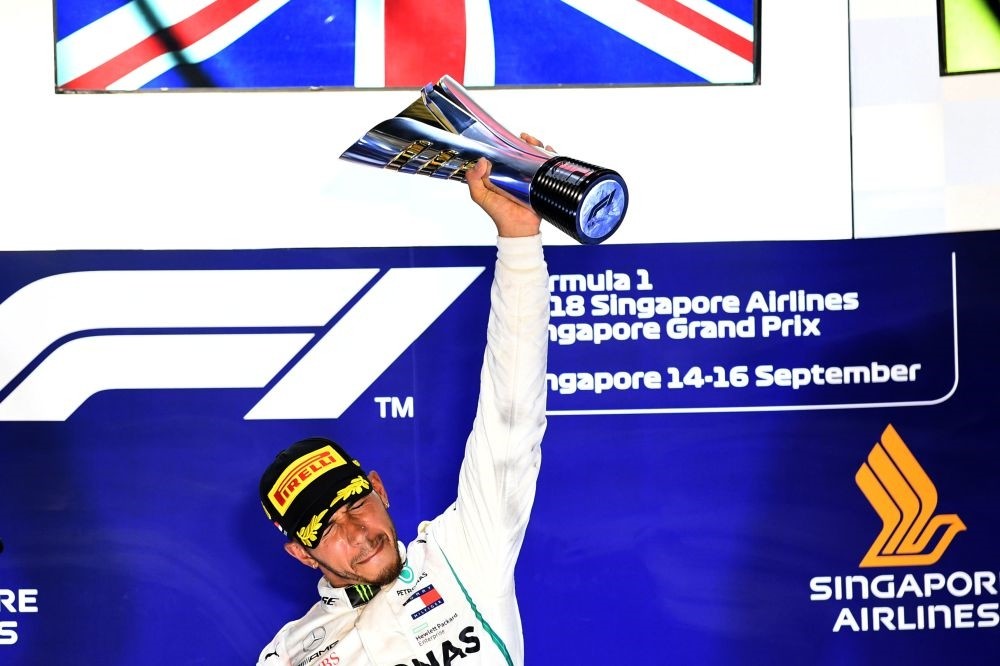 Mercedes' British driver Lewis Hamilton holds up the trophy on the podium after winning the Singapore Formula One Grand Prix at the Marina Bay Street Circuit in Singapore on Sept. 16.