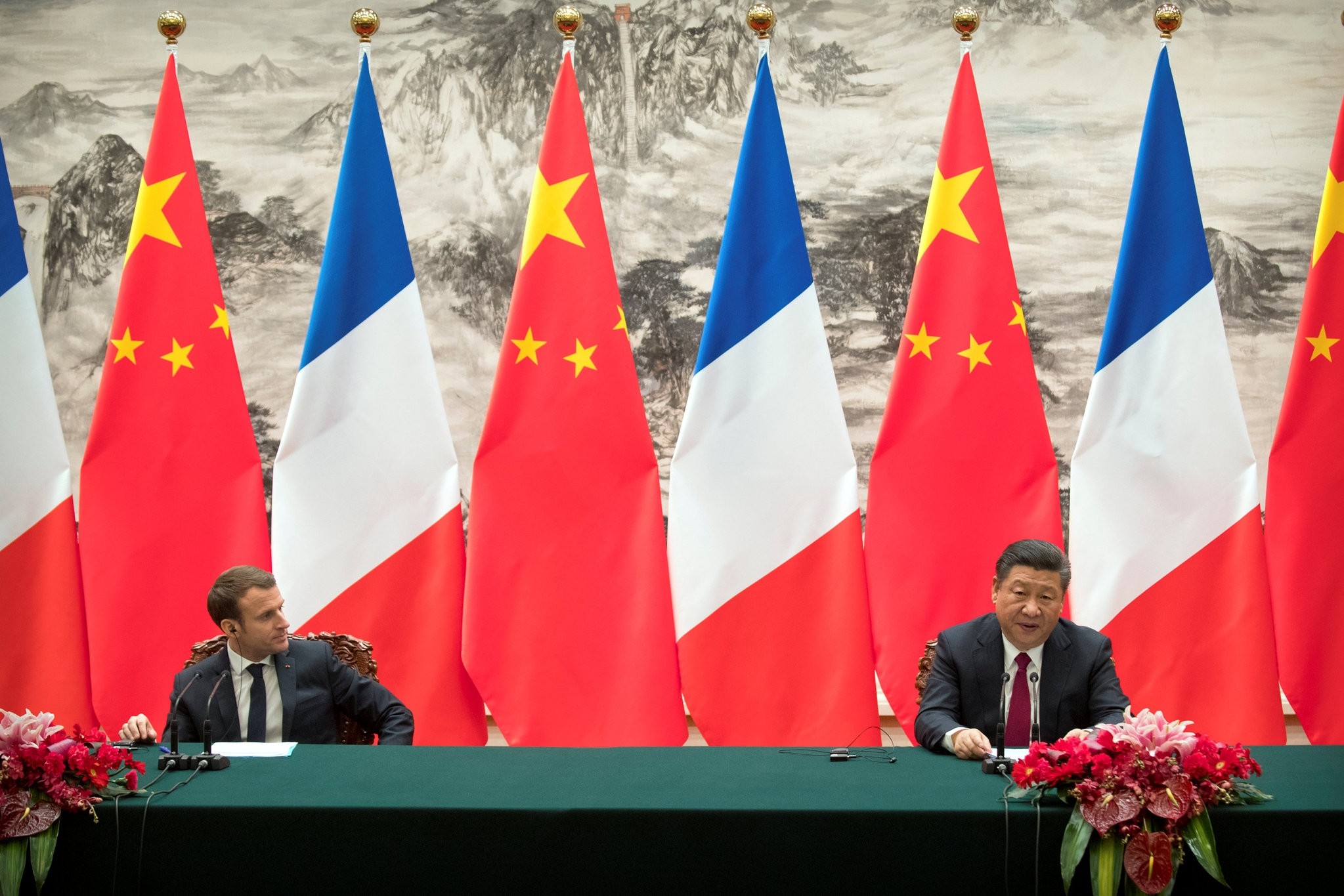 French President Emmanuel Macron, left, listens as Chinese President Xi Jinping speaks during a joint press briefing at the Great Hall of the People in Beijing, China January 9, 2018. (REUTERS Photo)