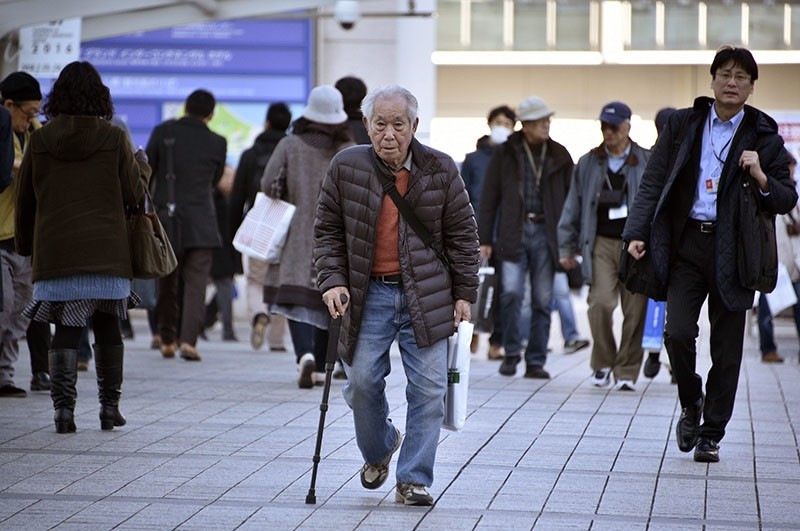 An elderly man walks with a stick in Yokohama, near Tokyo, Japan, Feb. 26, 2016. (EPA Photo)