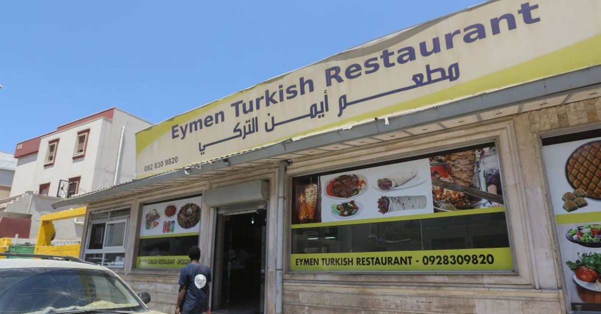 A Libyan man walks past a Turkish restaurant in Tripoli, June 30, 2019.