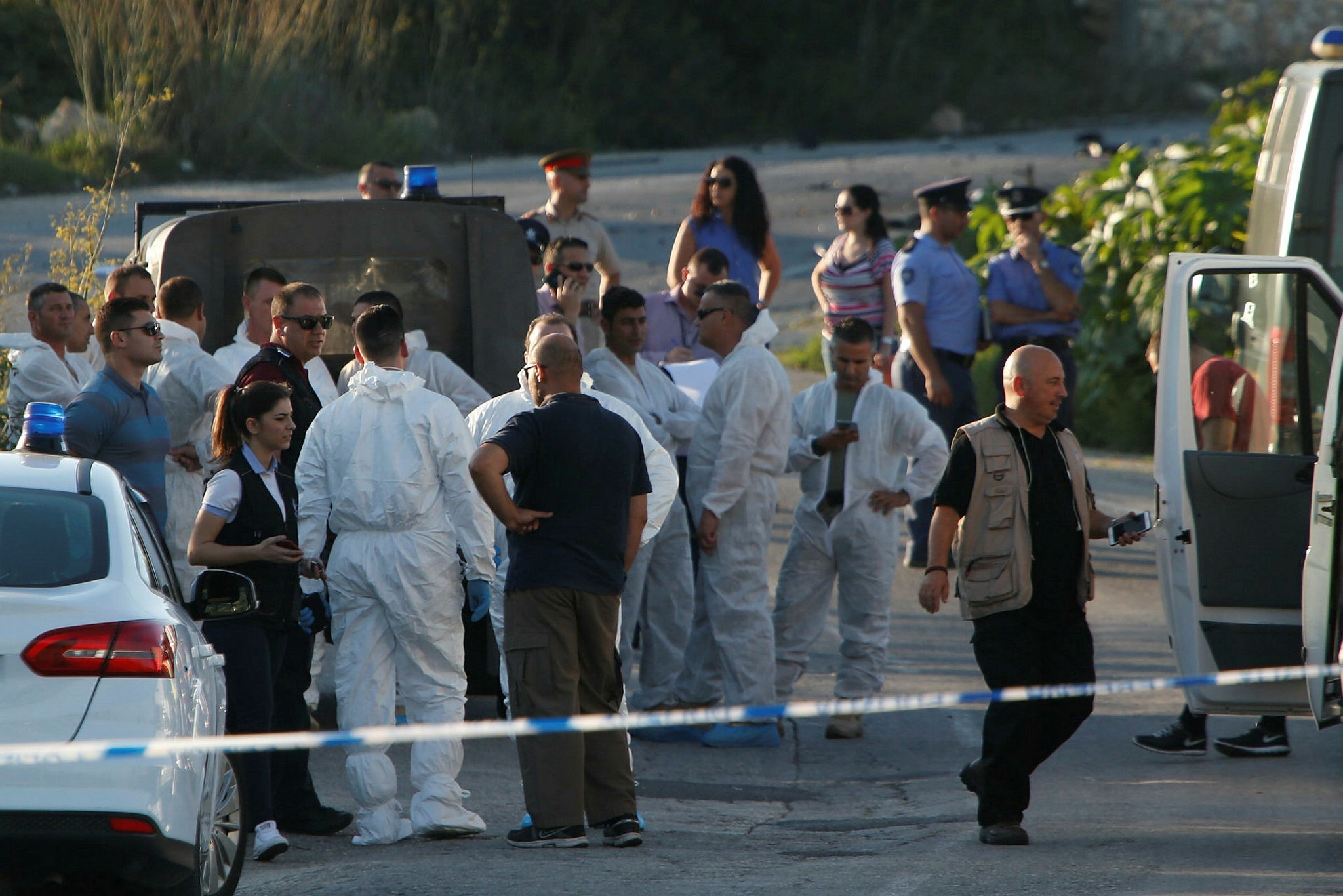 Police and forensics experts stand behind a road block after a powerful bomb blew up a car killing investigative journalist Daphne Caruana Galizia in Bidnija, Malta, October 16, 2017. (Reuters Photo)