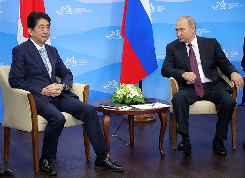Russian President Vladimir Putin (C) and Japanese Prime Minister Shinzo Abe (L) during their bilateral meeting on the sidelines of the Eastern Economic Forum at the Far Eastern Federal University (EPA Photo)