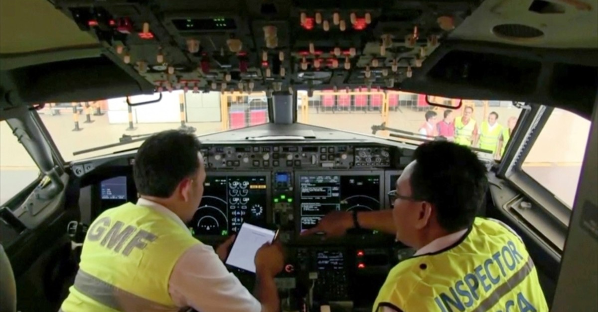 In this image from video taken on Tuesday, March 12, 2019, officials make inspection inside the cockpit of a Boeing 737 Max 8 aircraft is in hangar  at Garuda Maintenance Facility at Soekarno Hatta airport, Jakarta. (AP Photo)