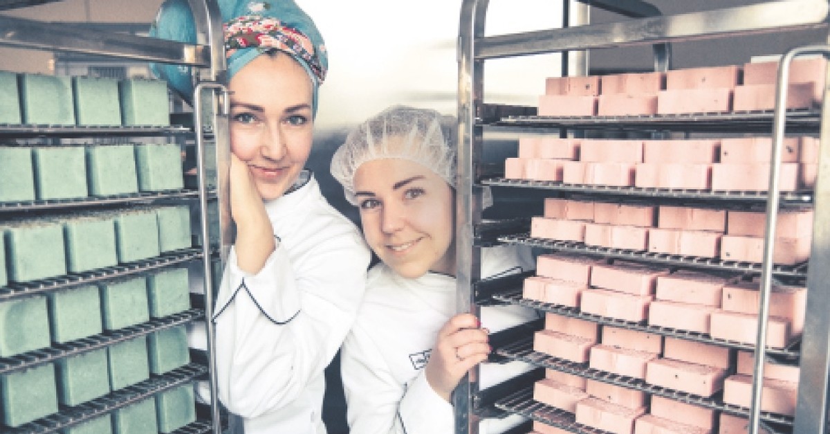 Ania (L) and Ula Bielun stand beside handmade soaps produced in their facility in the port city of Szczecin, the capital of the West Pomerania Province and the seventh largest city of Poland.
