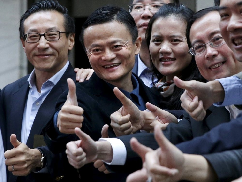 Alibaba Group founder Jack Ma (2nd L) poses as he arrives at the New York Stock Exchange for his company's initial public offering in New York, Sept. 19, 2014.