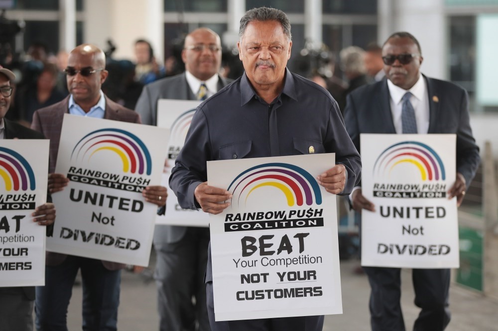 Civil rights leader Reverend Jesse Jackson leads a small group from the Rainbow PUSH Coalition in a protest outside the United Airlines terminal at O'Hare International Airport in Chicago.