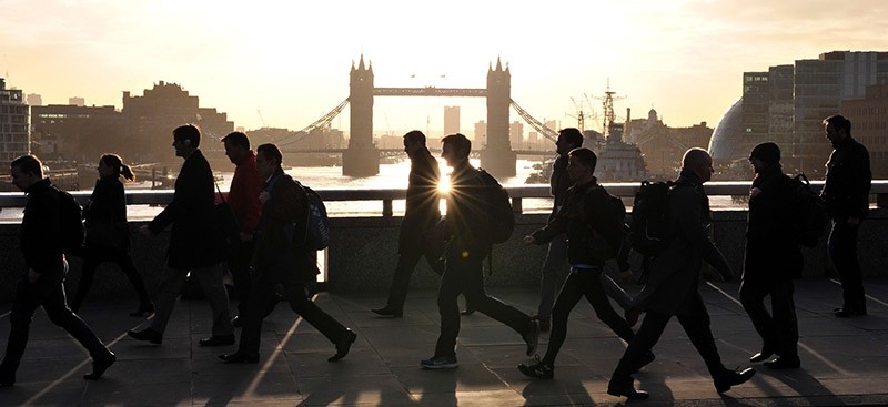 Morning commuters walk across London Bridge with Tower Bridge in the background into the City of London on March 2, 2017. (AFP Photo)