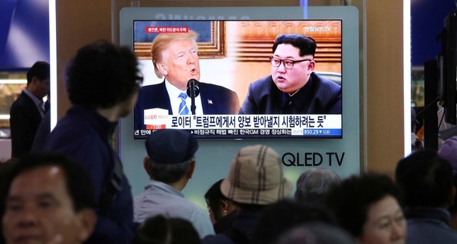 People watch a TV screen showing file footage of U.S. President Donald Trump, left, and North Korean leader Kim Jong Un during a news program at the Seoul Railway Station in Seoul, South Korea, Wednesday, May 16, 2018. (AP Photo)