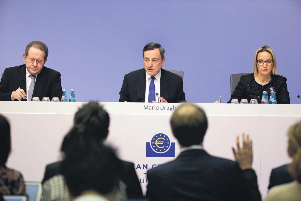 President of the European Central Bank (ECB), Mario Draghi (C), is flanked by Vitor Constancio (L), Vice-President of the European Central Bank, as he speaks to media during a press conference.