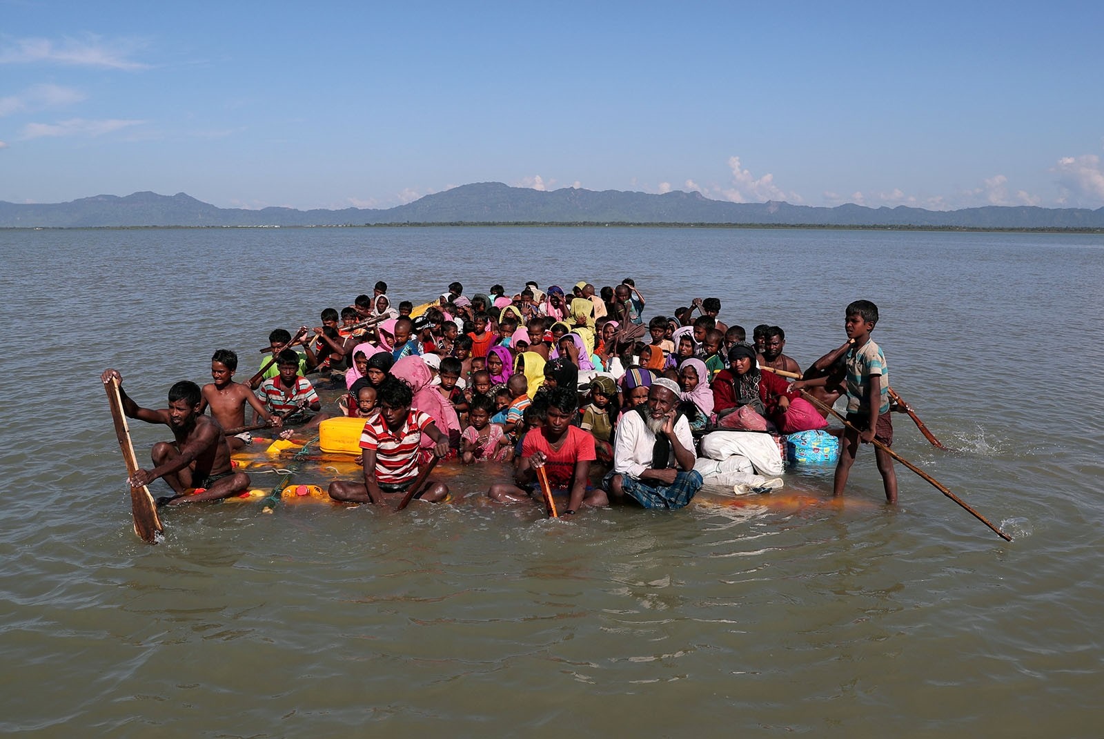 Rohingya refugees cross the Naf River with an improvised raft to reach to Bangladesh at Sabrang near Teknaf, Bangladesh November 10, 2017.