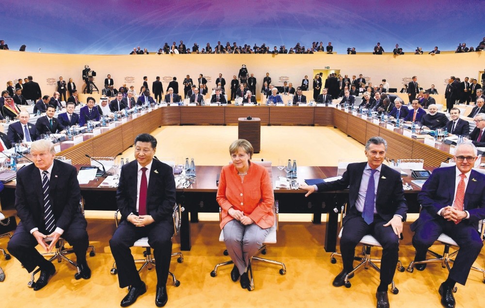 (From L - R) U.S. President Trump, Chinese President Xi, German Chancellor Merkel, Argentiniau2019s President Macri and Australian PM Turnbull sit for photographers at the start of the first working session of G20 meeting, Hamburg, Germany, July 7, 2017.