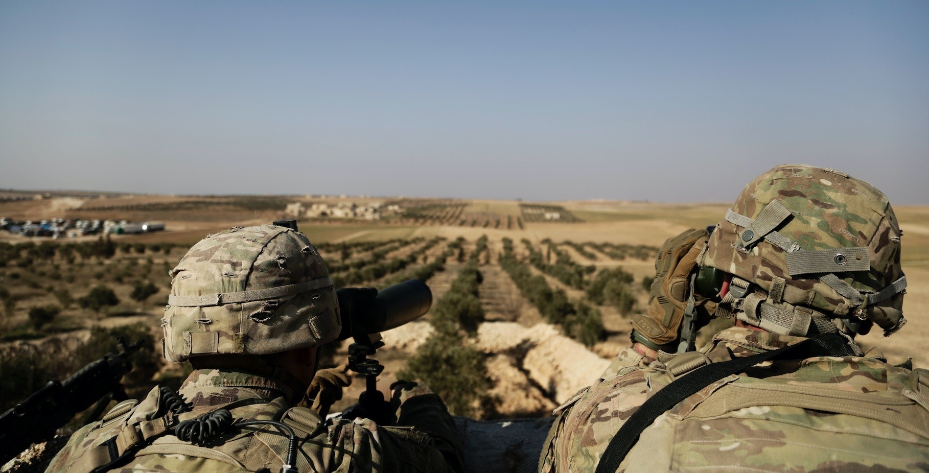 American troops look out toward the border with Turkey from a small outpost near the town of Manbij, northern Syria, Feb. 7. 