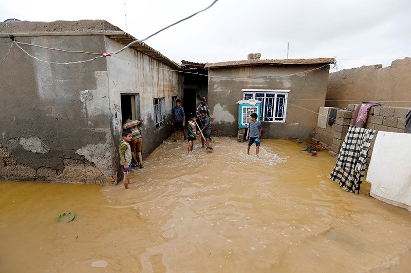 Iraq boys clean their house after heavy rainfall in al-Aziziyah, Iraq Nov. 25, 2018. (Reuters Photo)