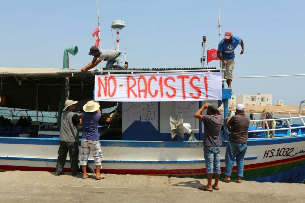 Tunisian fishermen hang banners in the port of Zarzis in southeastern Tunisia, Aug. 6.