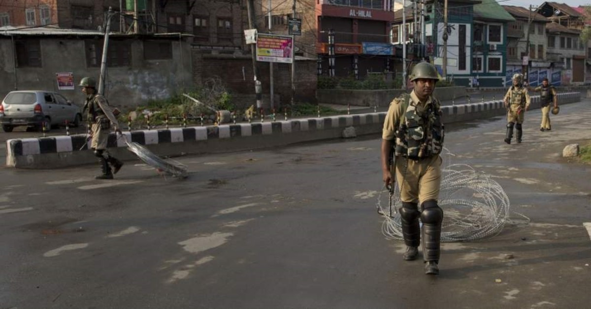 Indian paramilitary soldiers drag barbwire as they prepare to impose curfew in Srinagar, Indian controlled Kashmir, Aug. 7, 2019. (AP PHOTO)
