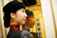 Elevator operator Yuria Nagamoto works at Takashimaya department store in Tokyo, Oct. 18.