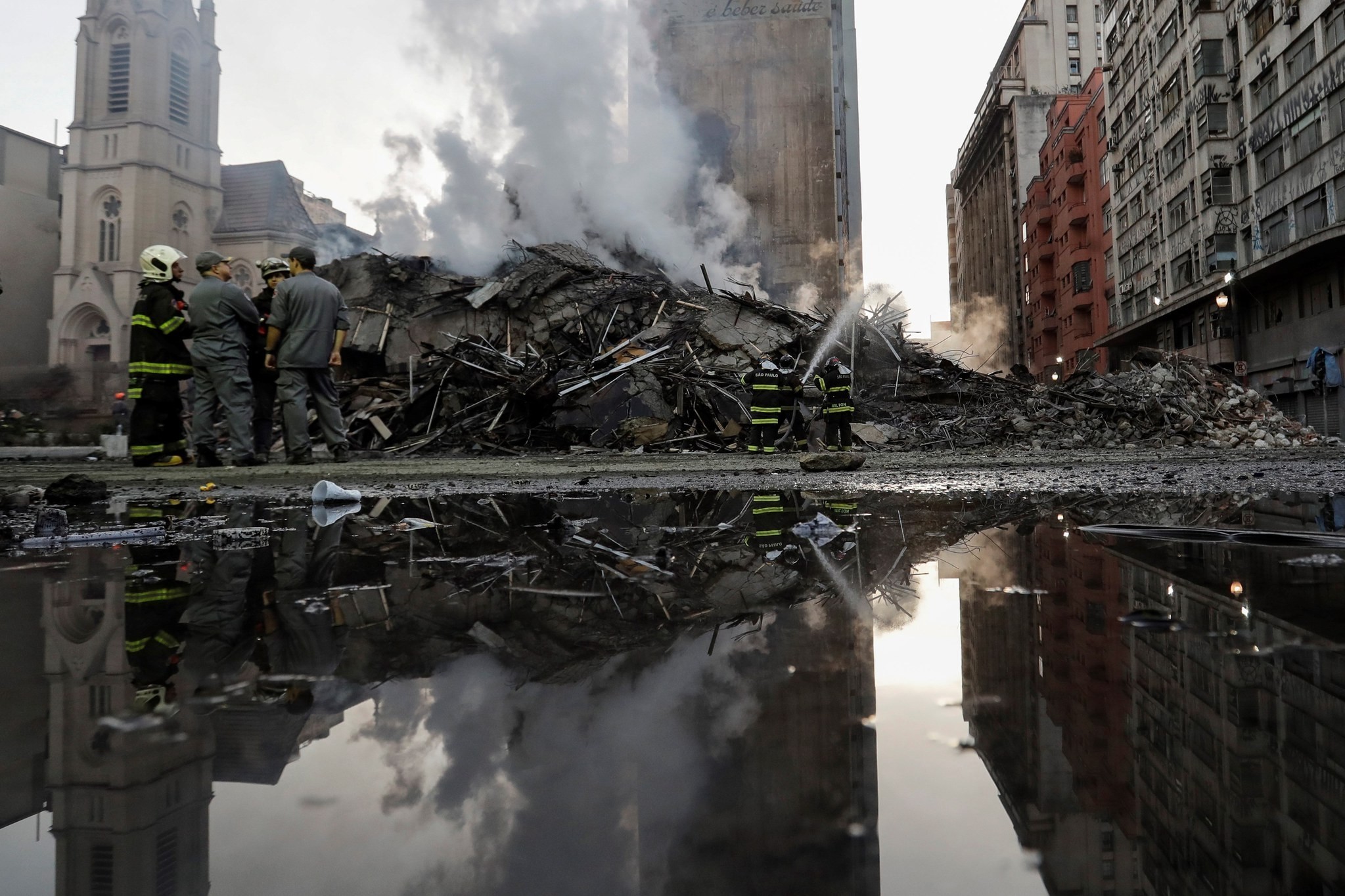Brazilian firefighters stand in front of the debris of a 24-storey building that collapsed after a fire broken out the previous day resulting in at least one person dead, in downtown Sao Paulo, Brazil, May 2, 2018. (EPA Photo)