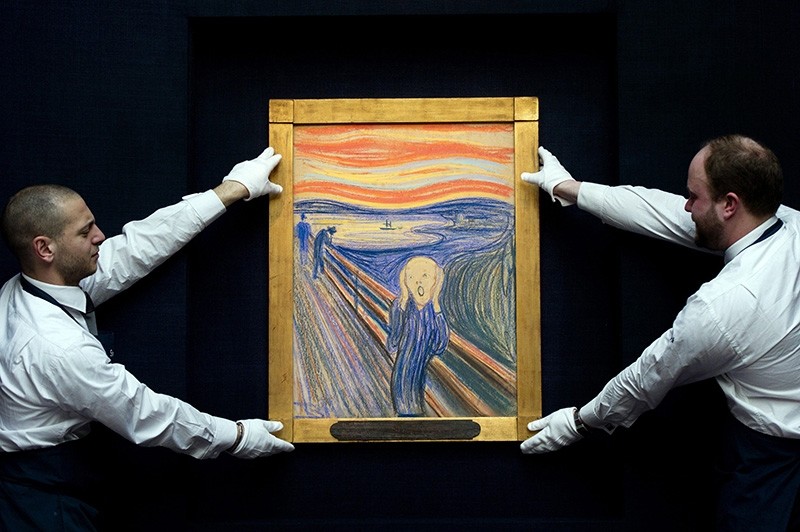 This April 12, 2012 file photo shows Sotheby's employees posing with Norwegian artist Edvard Munch's 1895 pastel on board version of 'The Scream' at Sotheby's auction house in central London (AFP Photo)