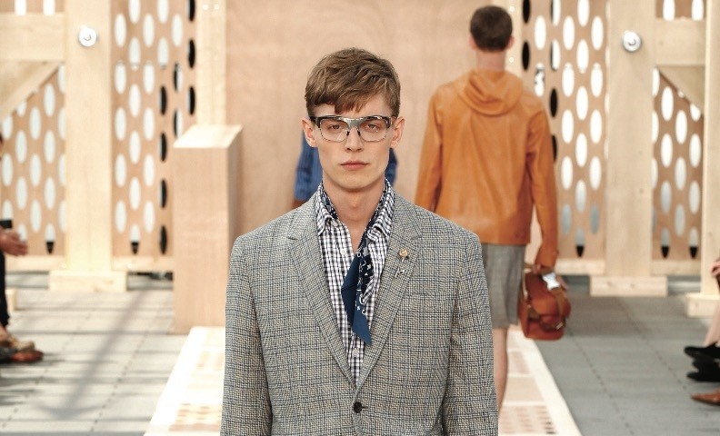 A male model in a Louis Vuitton suit.