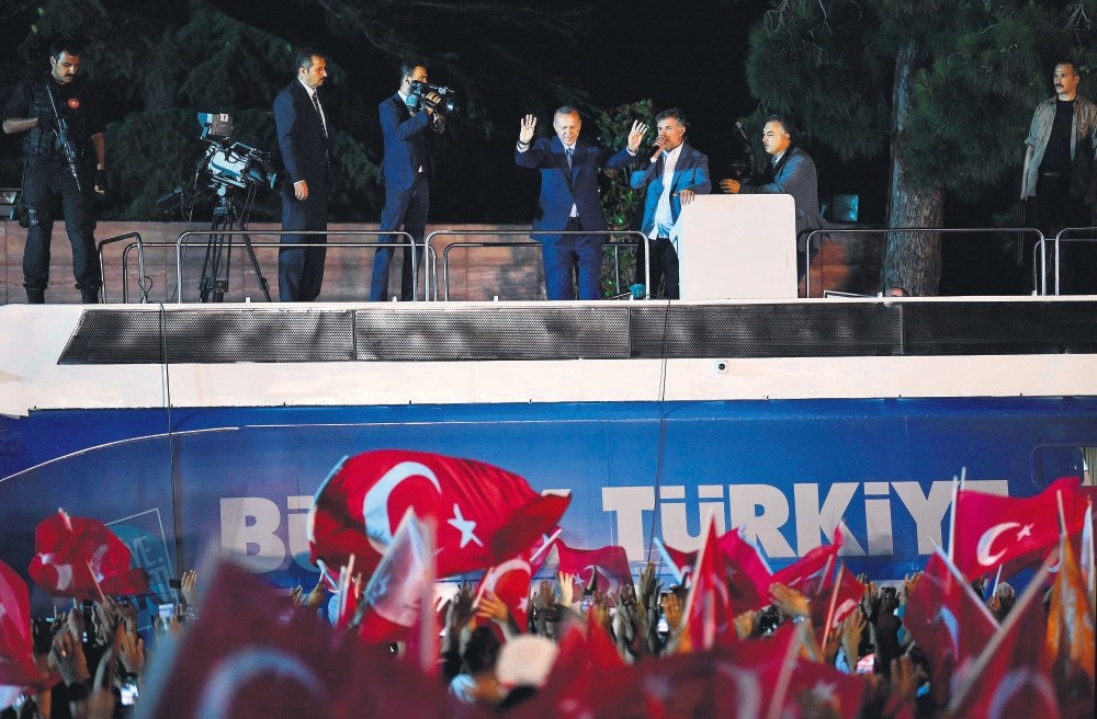 President Erdou011fan (C) waves to supporters celebrating the election results, Istanbul, Sunday.