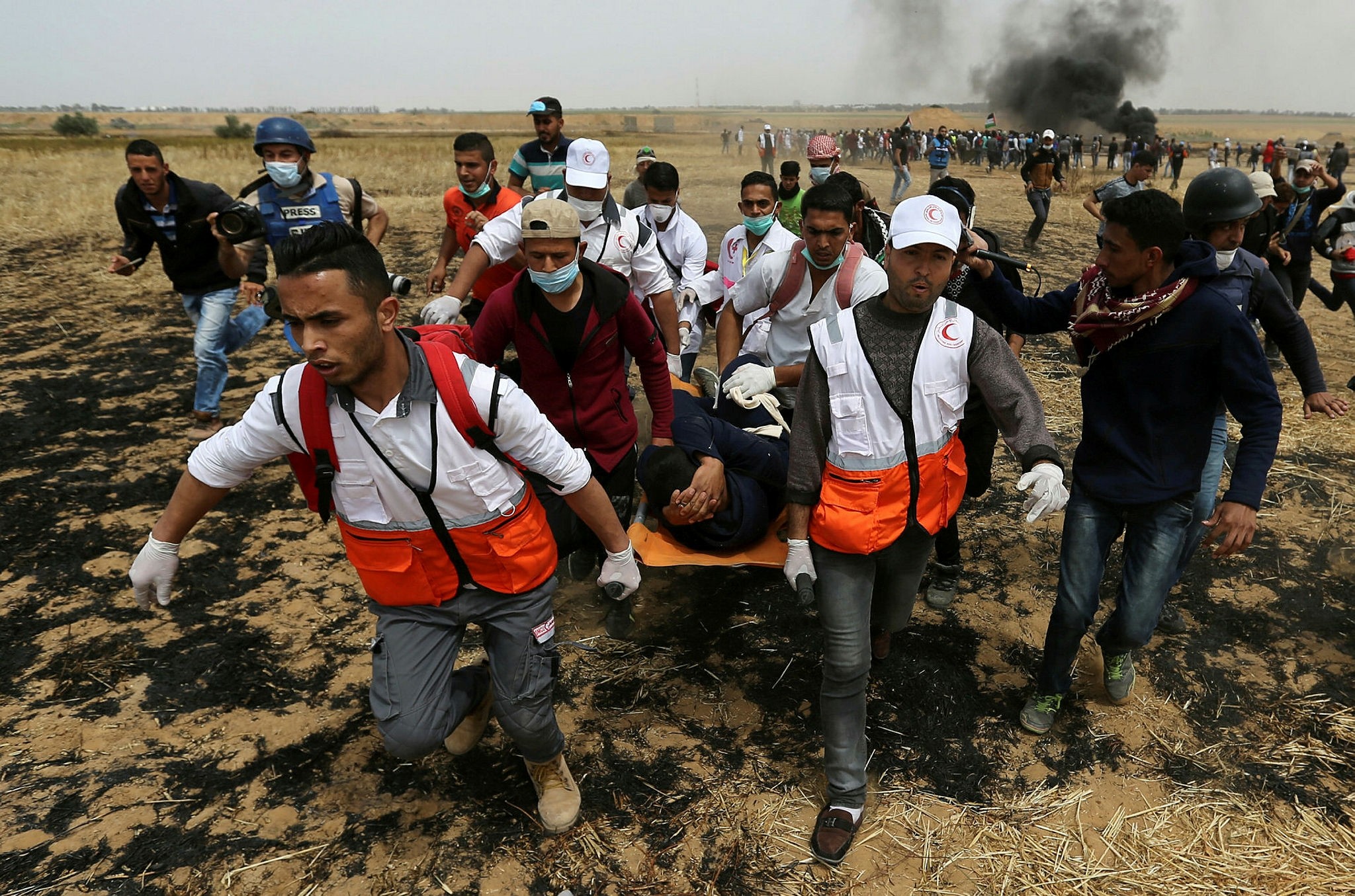A wounded Palestinian is evacuated during clashes with Israeli troops at the Israel-Gaza border, southern Gaza Strip, April 20.