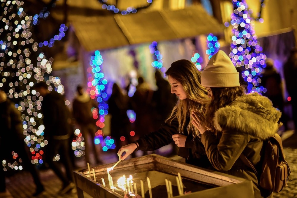 Worshippers light candles as they attend Christmas mass at Saint Antuan Church in the Beyou011flu district of Istanbul.