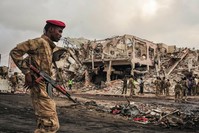 Somali soldiers patrol on the scene of a truck bomb explosu0131on in Mogadishu on October 15, 2017.