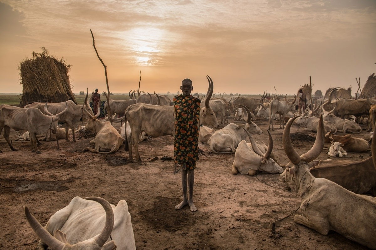 Den, 14, does not attend school but works as a cattle keeper, cook, cleaner and aid to her brother. The Dinka comprise of many independent but interlinked clans.