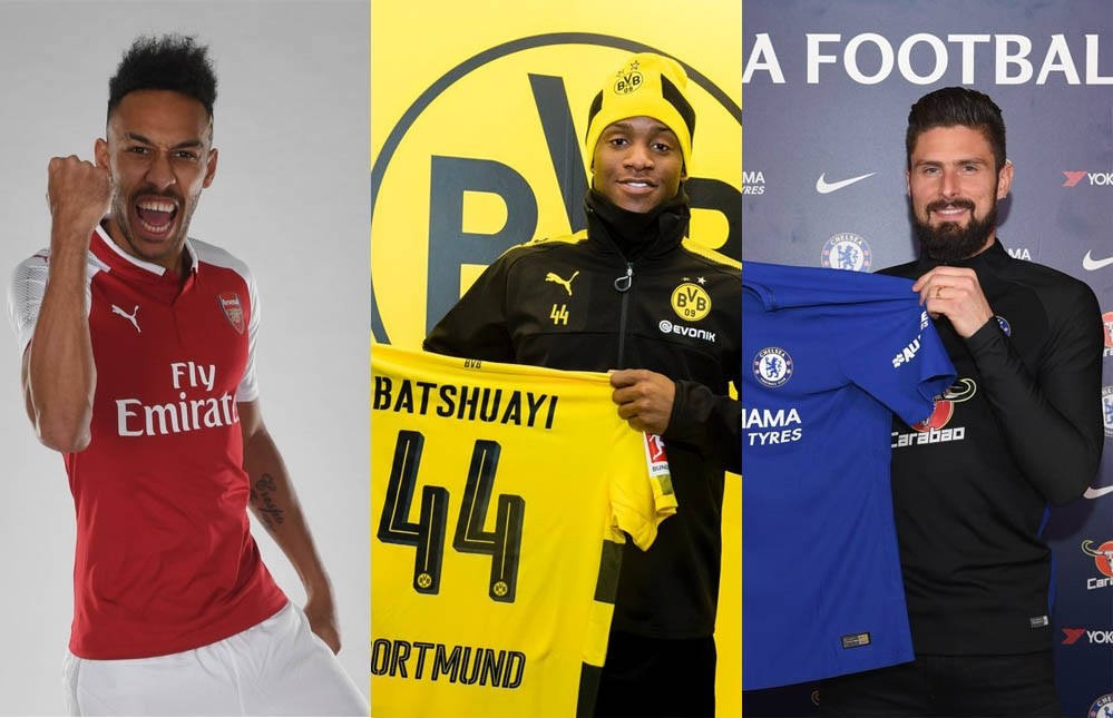 Pierre-Emerick Aubameyang, left, Michy Batshuayi, center, and Olivier Giroud pose with t-shirts of their new clubs.