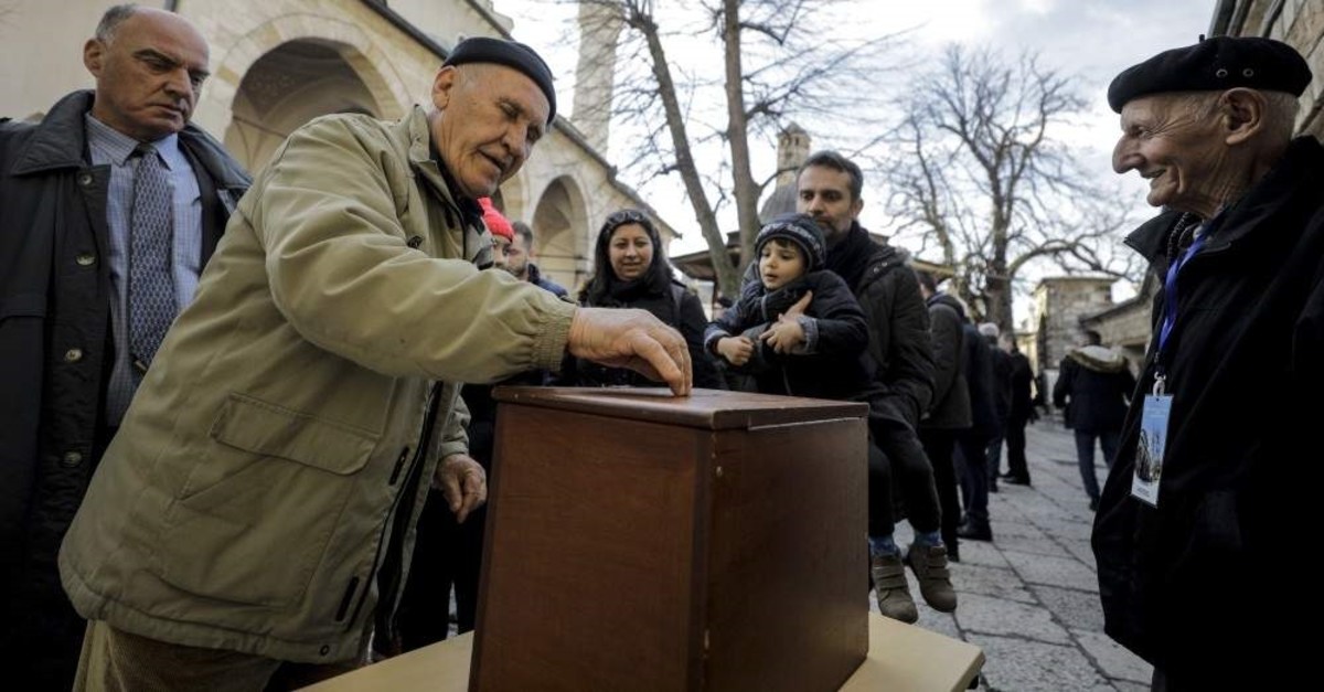 People put money inside a donation box outside a mosque in Sarajevo, Jan. 31, 2020. (AA Photo) 