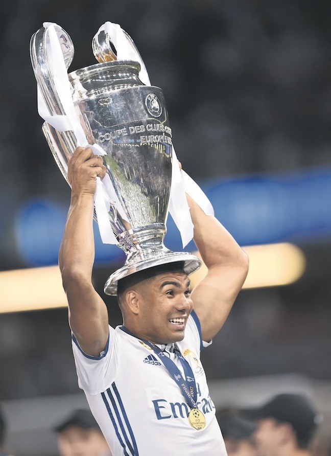 Real Madridu2019s Brazilian midfielder Casemiro lifts the trophy after Real Madrid won the UEFA Champions League final.