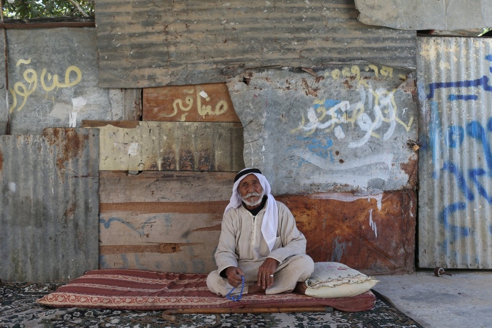 An elderly Palestinian man sits at his house in the southern Gaza Strip, Oct. 11.