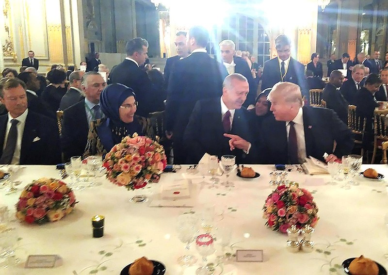 President Recep Tayyip Erdou011fan (C), first lady Emine Erdou011fan (L) and U.S. President Donald Trump (R) talk during dinner hosted by French President Emmanuel Macron in Paris. (AA Photo)