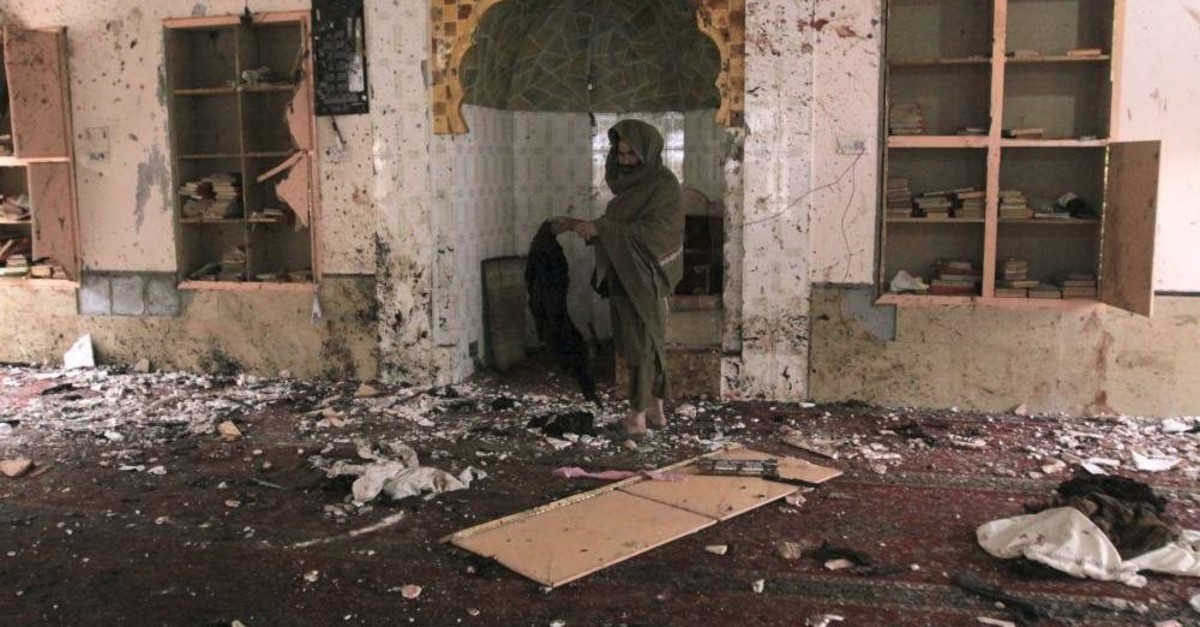 A Pakistani examines the site of Friday's bomb explosion inside a mosque in Quetta, Pakistan, Saturday, Jan. 11, 2020. (AP Photo)