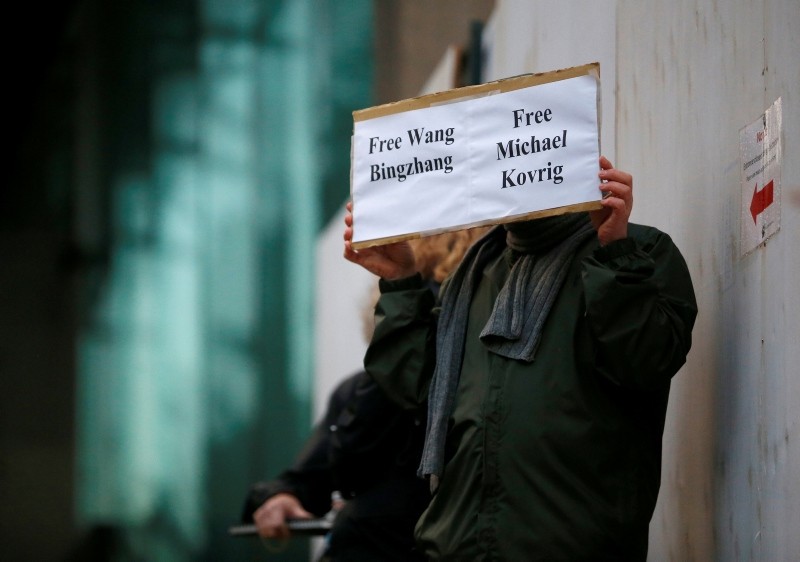 A man holds a sign calling for China to release Wang Bingzhang and former Canadian diplomat Michael Kovrig, at the B.C. Supreme Court bail hearing of Huawei CFO Meng Wanzhou in Vancouver, British Columbia, Canada Dec. 11, 2018. (Reuters Photo)